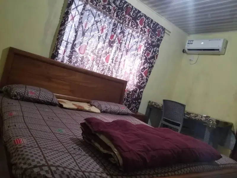 Room with AC and curtains — Yogi Guest House